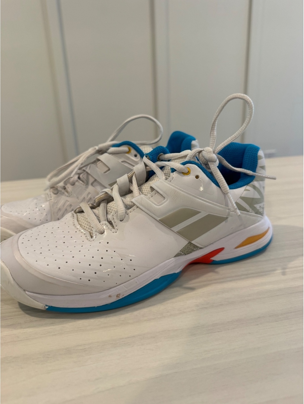 Babolat white court shoes with blue lining